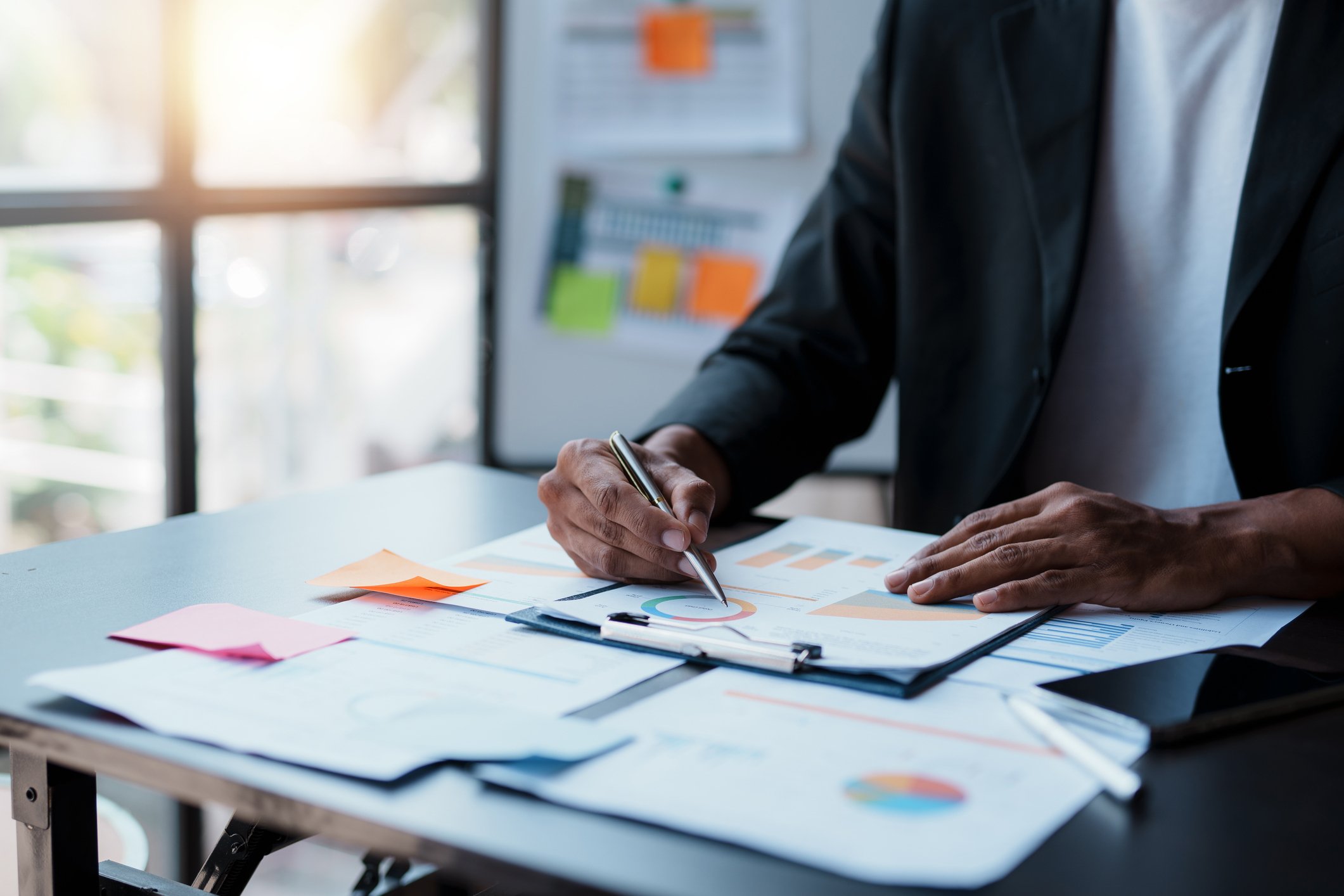 Business man pointing to expense chart image for the allocation of the company's next year's revenue budget